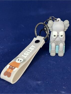 Gray and Light Blue Kaws Figure Keychain with White Strap